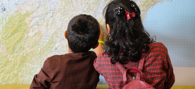 Two children looking at a map.