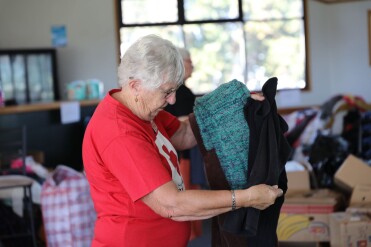 Older woman sorting through clothes