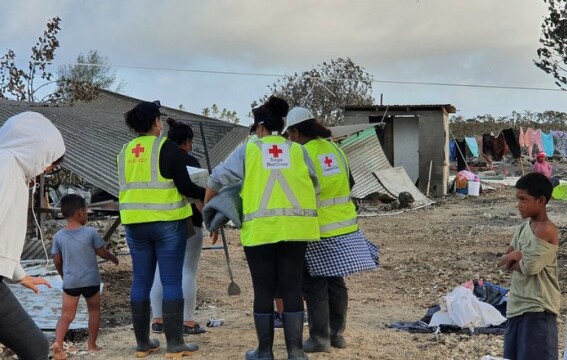 People next to destroyed buildings.