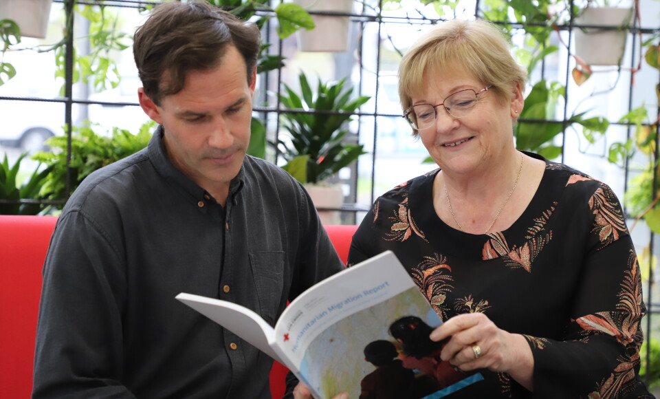 A man and woman looking at a report. 