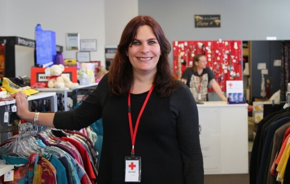 A woman in a retail shop smiling at the camera.