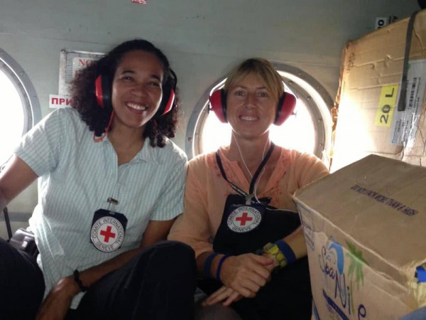 Two women sitting together in an aircraft.