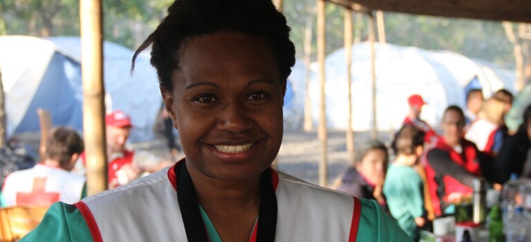 A woman smiling at the camera. 