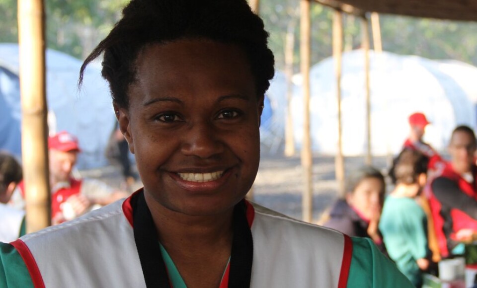 A woman smiling at the camera. 