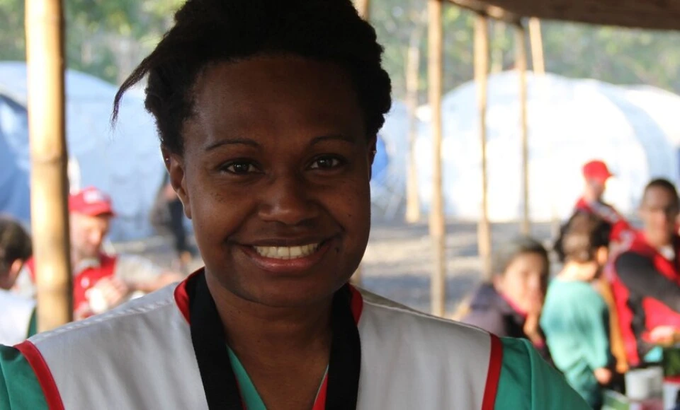 A woman smiling at the camera.