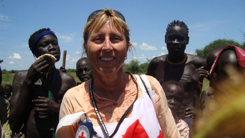 A woman standing with a group of men.