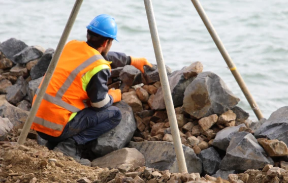 A man working on a seawall.