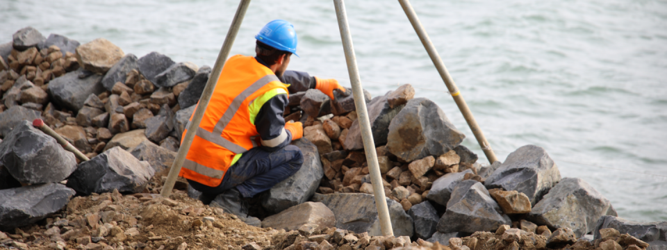 A man working on a seawall.