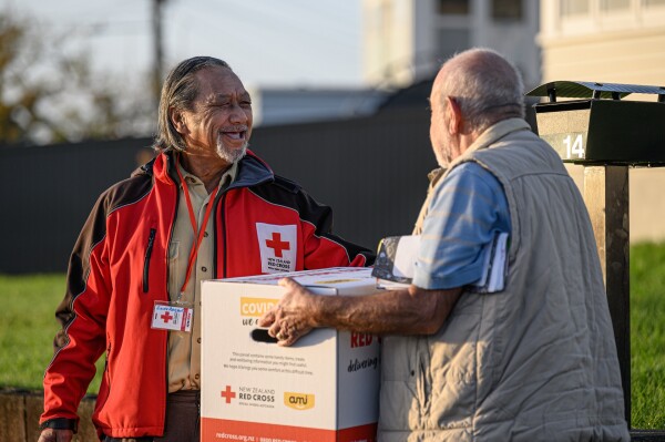 A man giving another man a parcel.