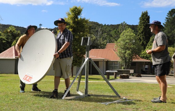 People installing a satellite dish. 