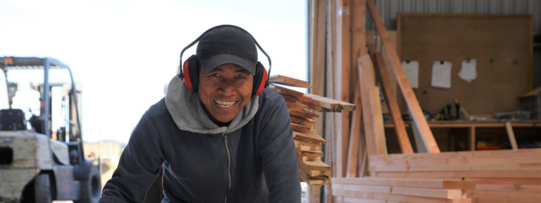 A man smiling and looking at the camera.