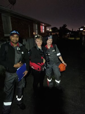 A man and two women standing together. 