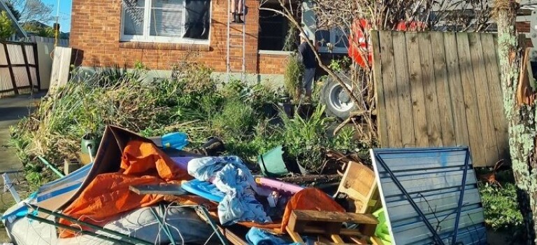 Destroyed belongings outside a house.