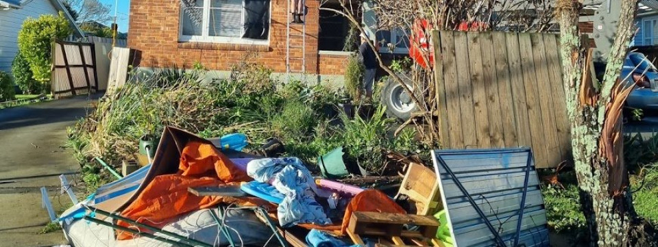 Destroyed belongings outside a house.