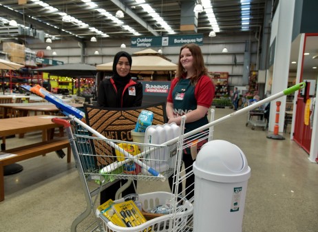 Bunnings’ staff handing over welcome pack donations