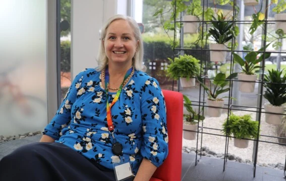 A blonde woman smiling.