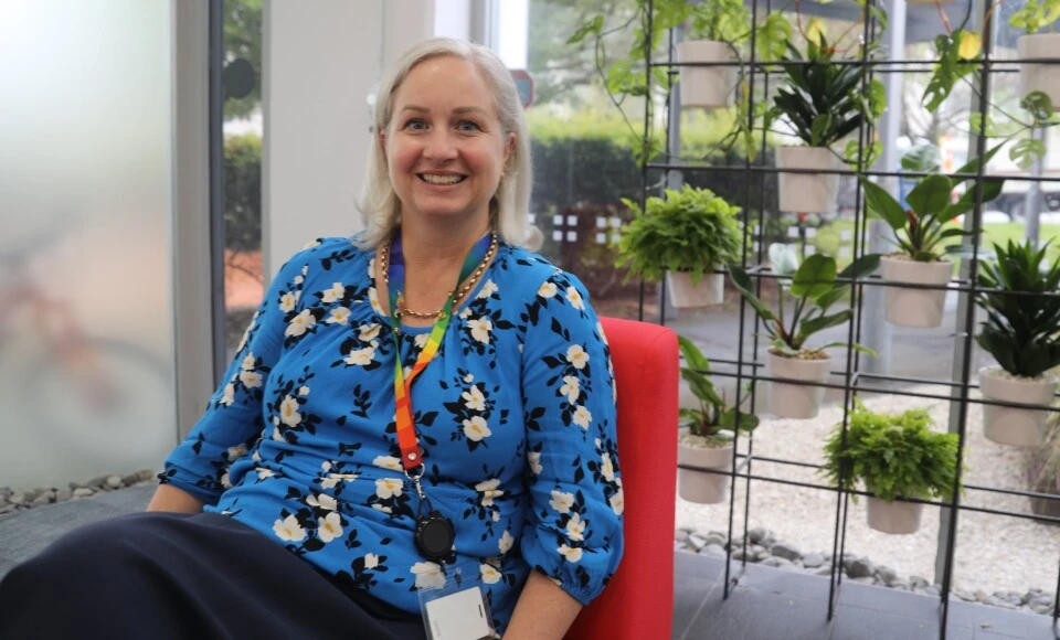 A blonde woman smiling.