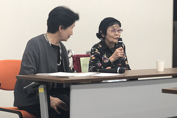 Two women sitting at a table.