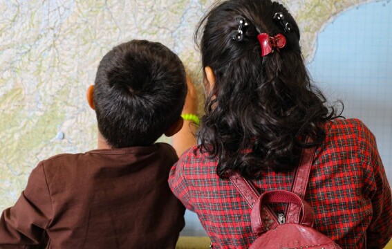 Two children looking at a map.