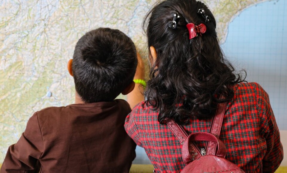 Two children looking at a map.