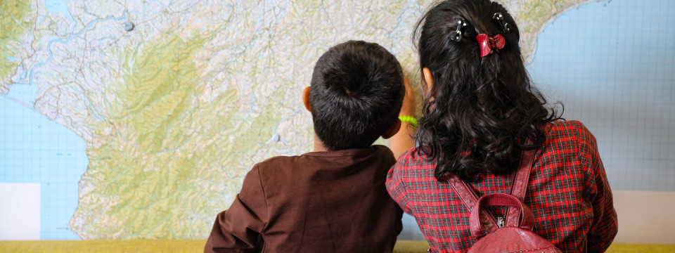 Two children looking at a map.