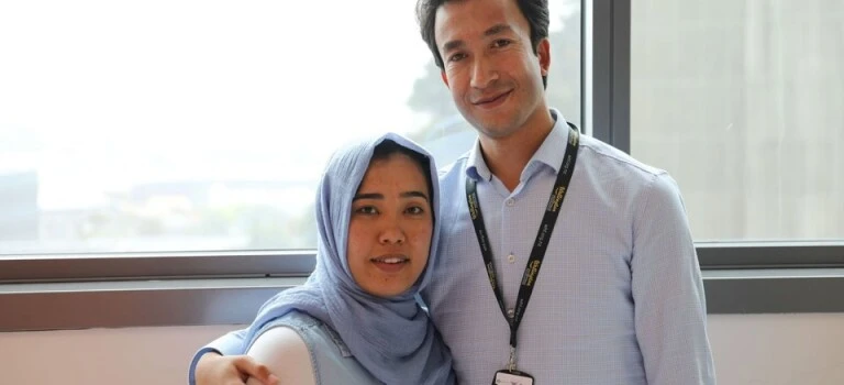 A woman and a man standing together.
