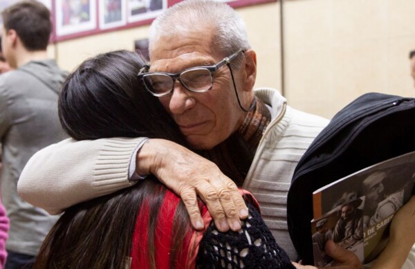 Man embracing Red Cross member