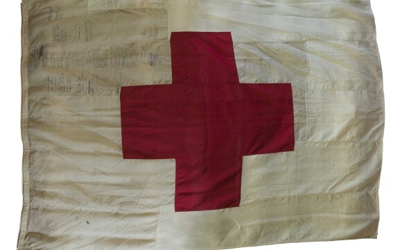 A Red Cross sewn onto a white flag