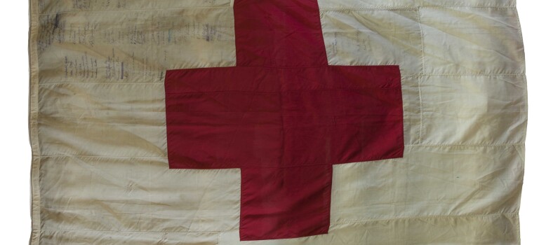 A Red Cross sewn onto a white flag