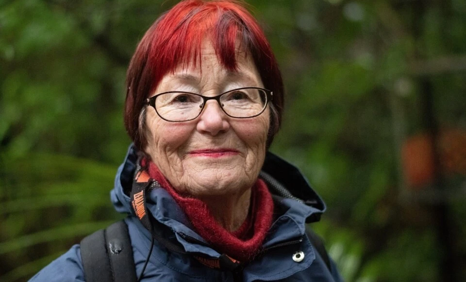 A woman with red hair smiling