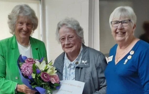 Three older women standing together