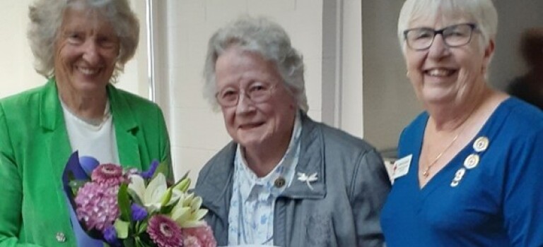 Three older women standing together