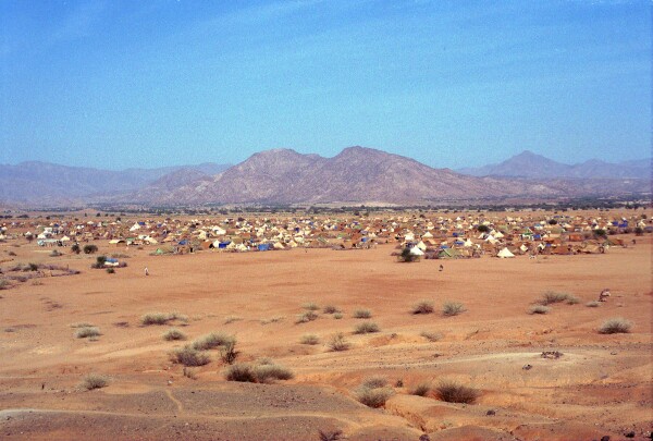 A view of tents spread across a desert 