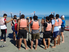 Young former refugees in Nelson try paddleboarding. 