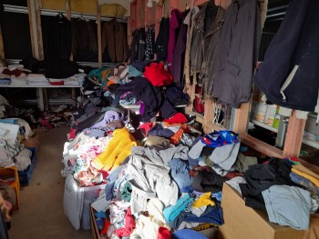 Boxes of unsorted donated clothes and goods