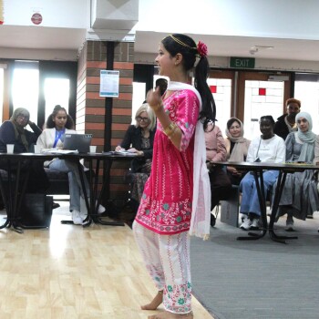 A young girl dancing in front of an audience
