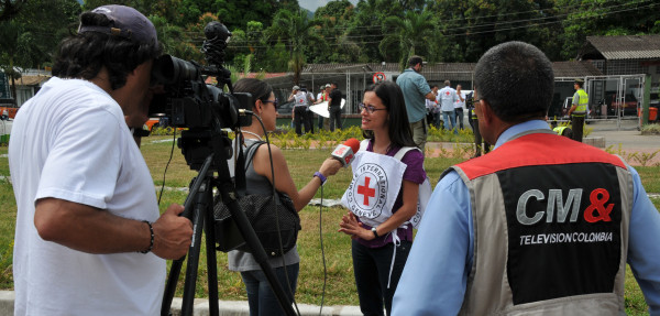 A woman being interviewed by a journalist. 