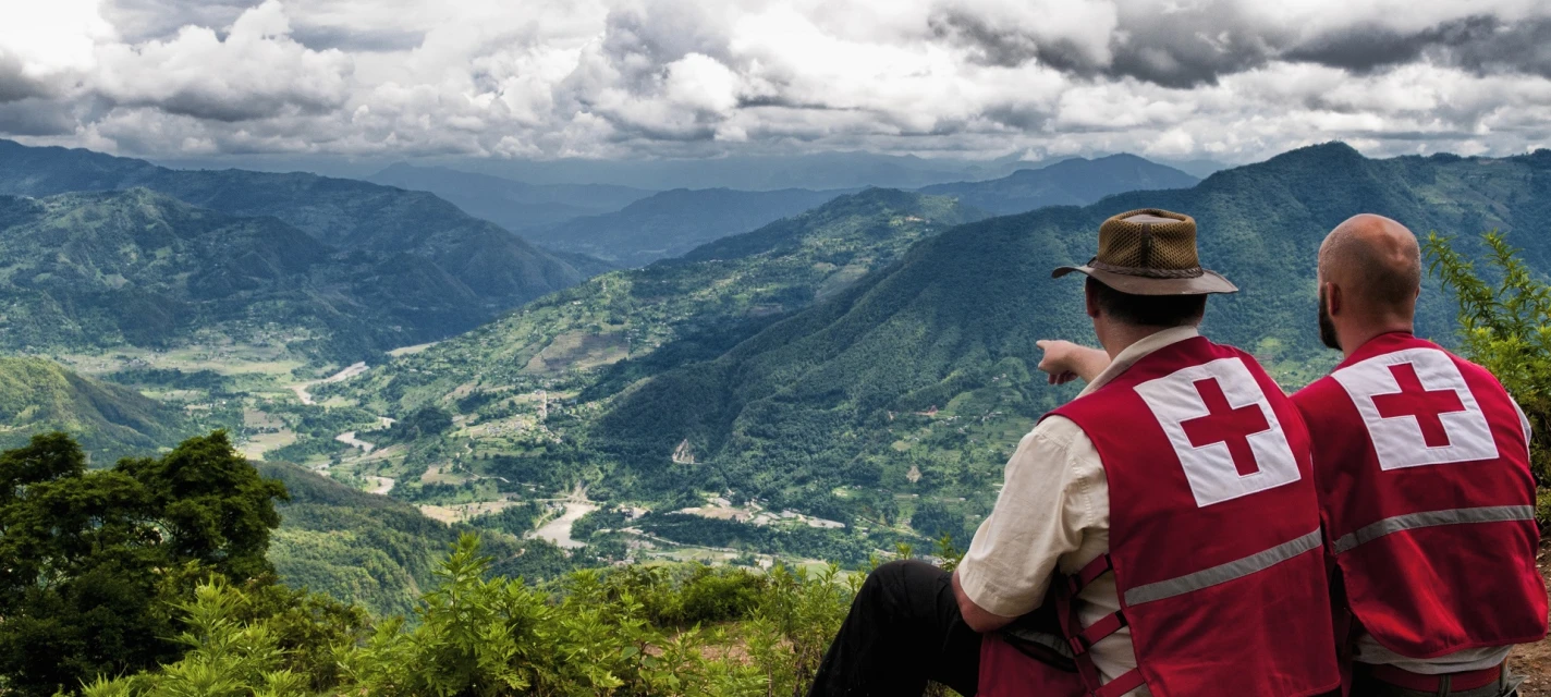 Two people looking out over a settlement.