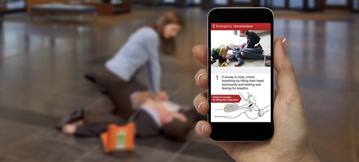 A phone screen shows how to do CPR while a person in the background follows the instructions