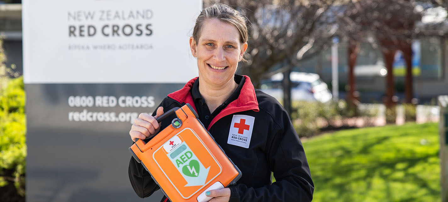 A volunteer holding a first aid kit