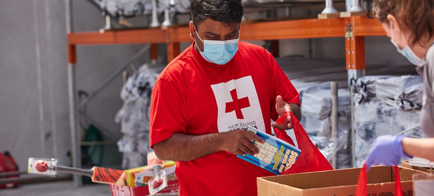 A man packing a bag of supplies