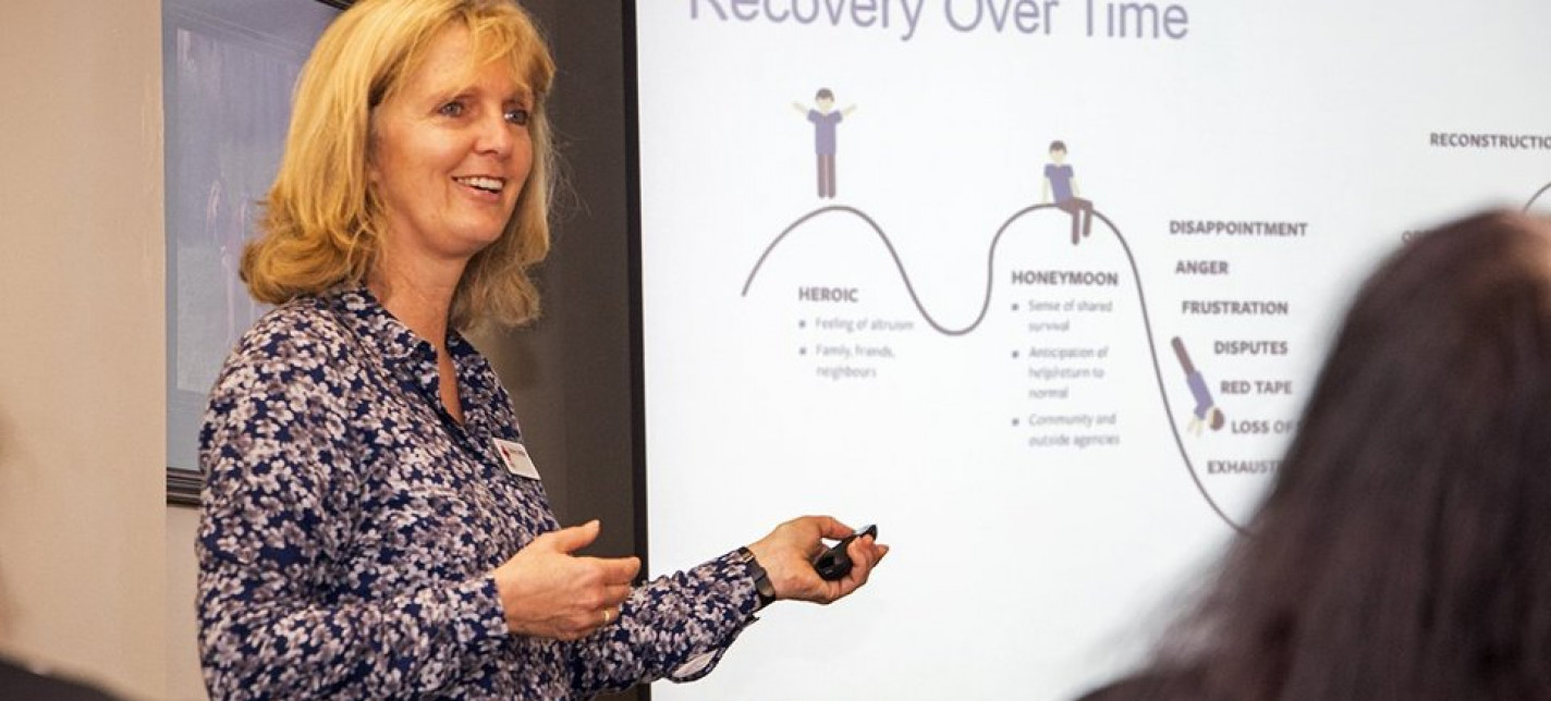 A woman smiles as she gives a presentation