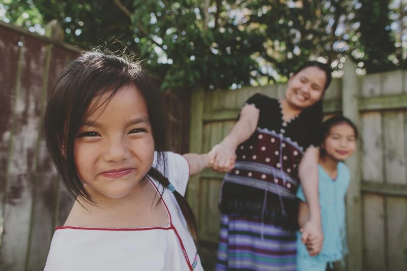A young girl smiling at the camera.
