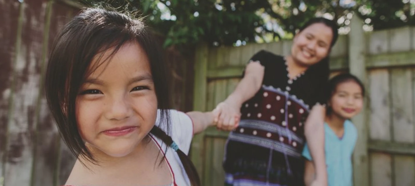 A young girl smiling at the camera.