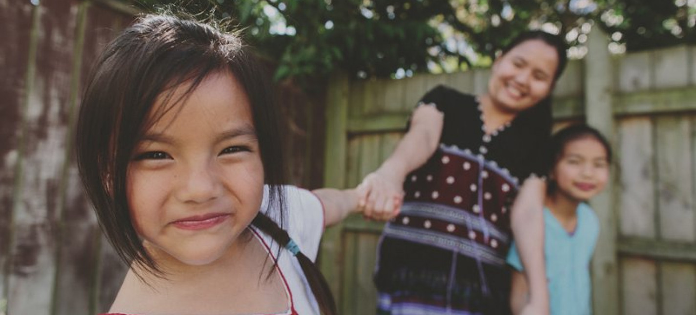 A young girl smiling at the camera.