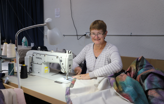 A woman at a sewing machine.