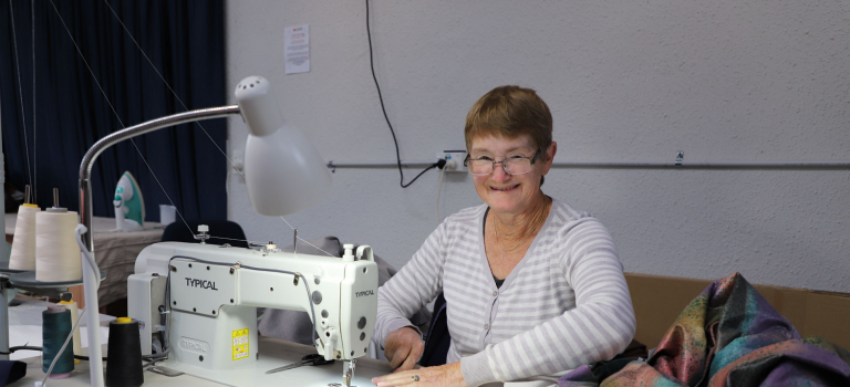 A woman at a sewing machine.