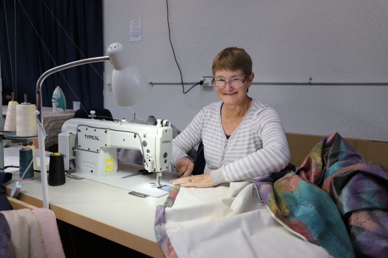 A woman at a sewing machine.