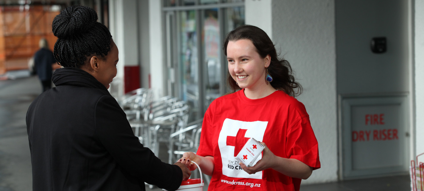 A person giving money to a fundraiser.