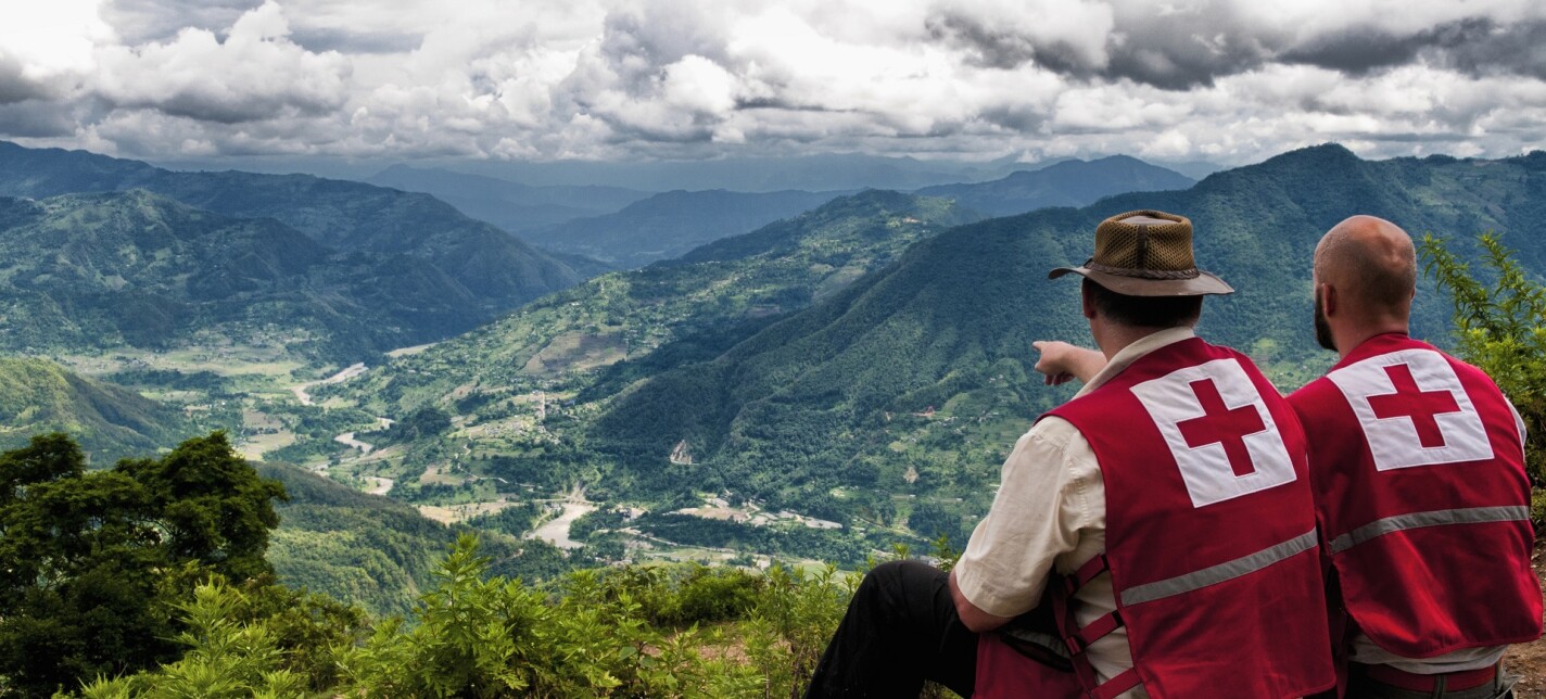 Two people looking out over a settlement.